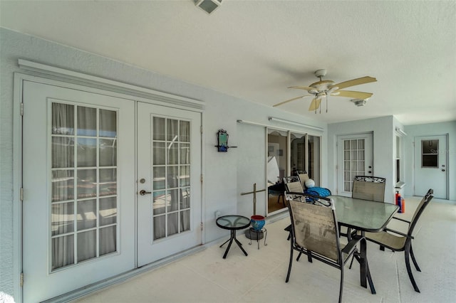 sunroom / solarium featuring french doors and ceiling fan