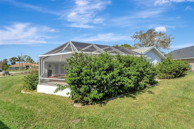 view of home's exterior with a lanai and a lawn