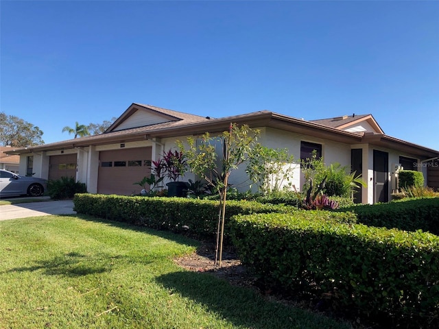 view of front of house with a front yard and a garage