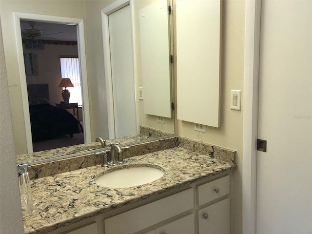 bathroom featuring ceiling fan and vanity