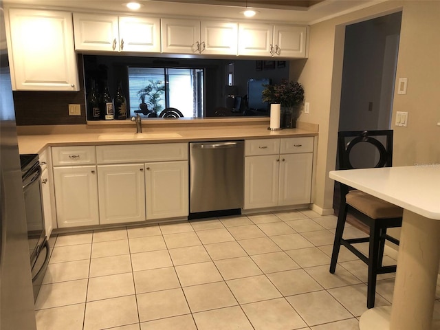 kitchen with dishwasher, white cabinets, and sink