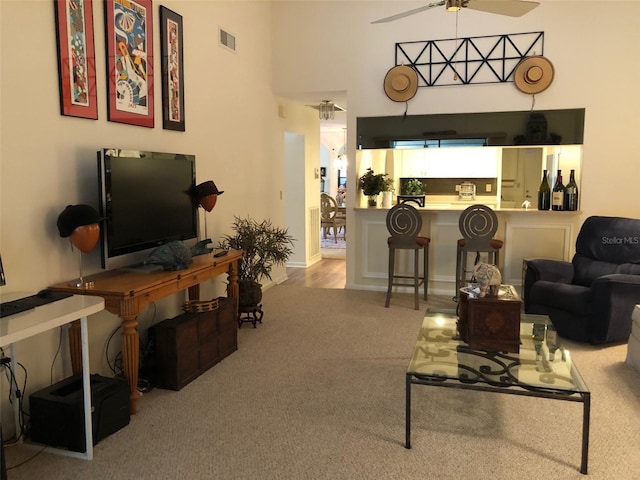 living room featuring ceiling fan and light carpet