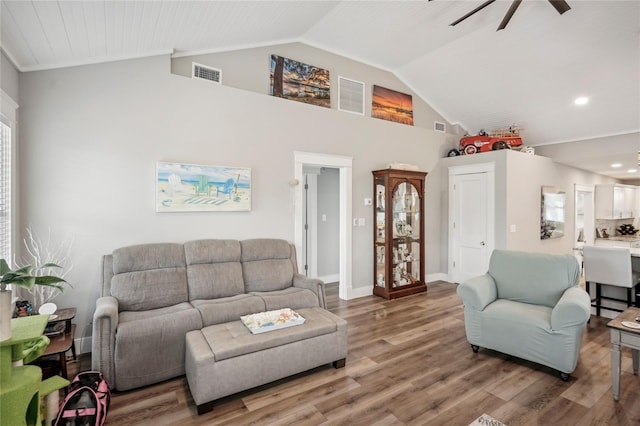 living room featuring hardwood / wood-style floors, ceiling fan, and lofted ceiling