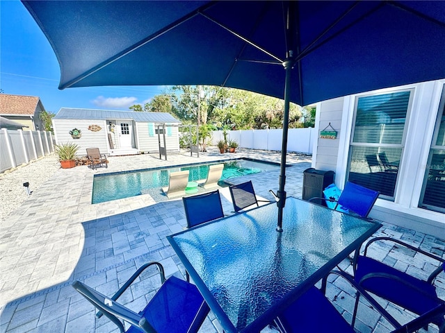 view of swimming pool with an outdoor structure and a patio