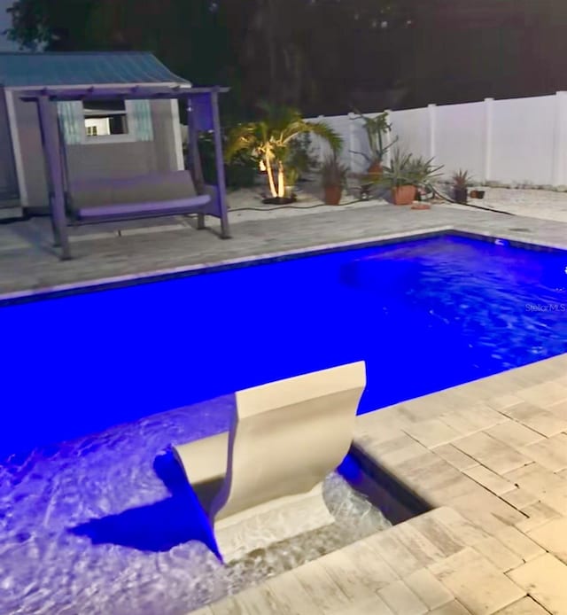 view of swimming pool with a patio area