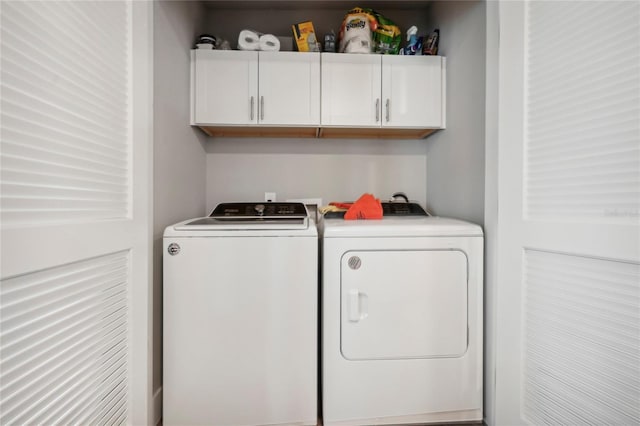 laundry room with cabinets and washer and clothes dryer