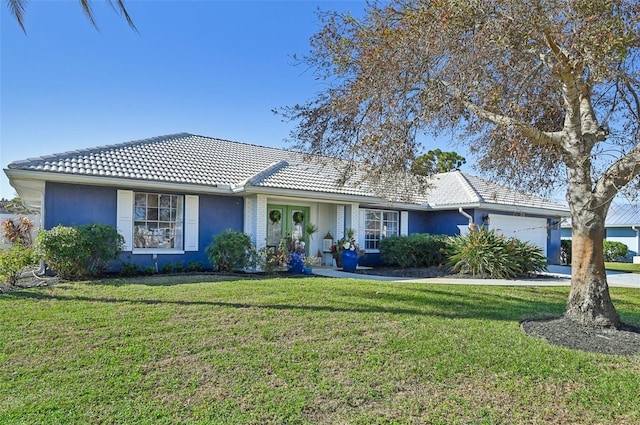 218 Brandywine Cir, Englewood, FL 34223 - single story home featuring a tiled roof, french doors, a front yard, an attached garage, and stucco siding