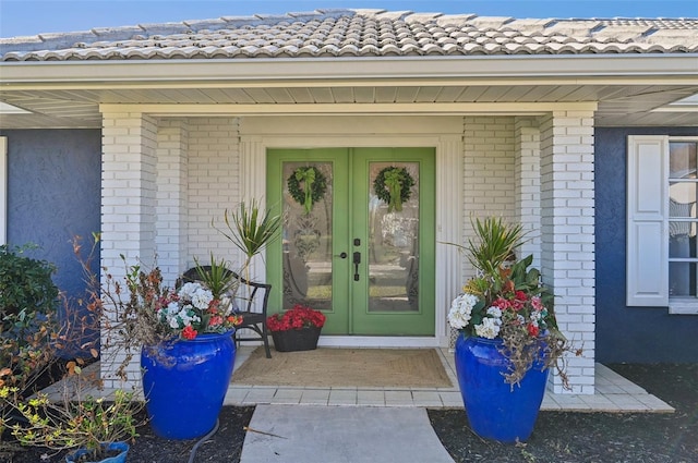 218 Brandywine Cir, Englewood, FL 34223 - property entrance featuring brick siding and french doors