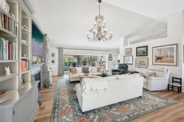 living room featuring light hardwood / wood-style floors, a fireplace, and vaulted ceiling