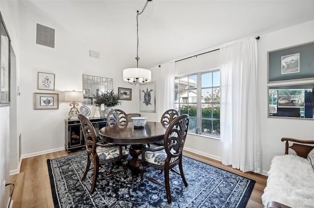 218 Brandywine Cir, Englewood, FL 34223 - dining space with visible vents, wood finished floors, and a chandelier