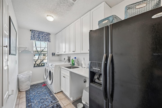 218 Brandywine Cir, Englewood, FL 34223 - clothes washing area with cabinet space, light tile patterned floors, a sink, and washer and dryer