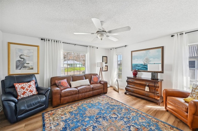 218 Brandywine Cir, Englewood, FL 34223 - living room with a textured ceiling, ceiling fan, and wood finished floors