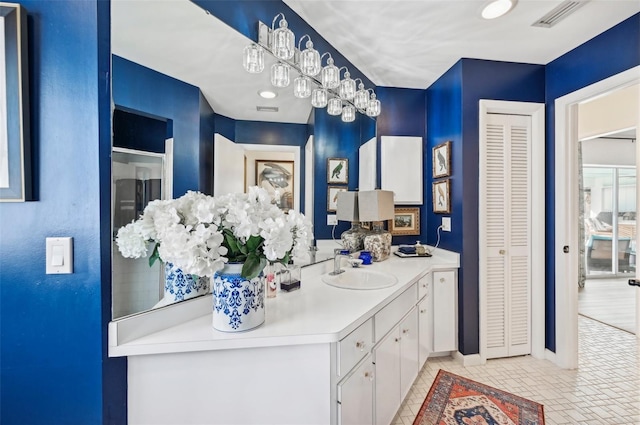 218 Brandywine Cir, Englewood, FL 34223 - bathroom with vanity, baseboards, visible vents, and a closet