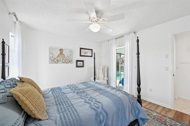 218 Brandywine Cir, Englewood, FL 34223 - bedroom featuring a textured ceiling, baseboards, a ceiling fan, and wood finished floors