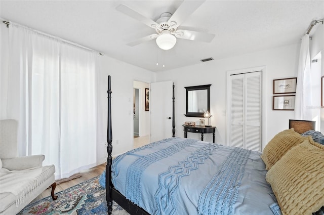 bedroom featuring a closet, ceiling fan, and light hardwood / wood-style floors