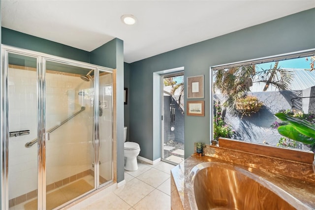 218 Brandywine Cir, Englewood, FL 34223 - bathroom with tile patterned flooring, toilet, baseboards, a bath, and a stall shower