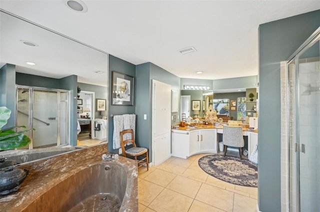 218 Brandywine Cir, Englewood, FL 34223 - full bath with tile patterned flooring, a garden tub, vanity, a shower stall, and ensuite bath