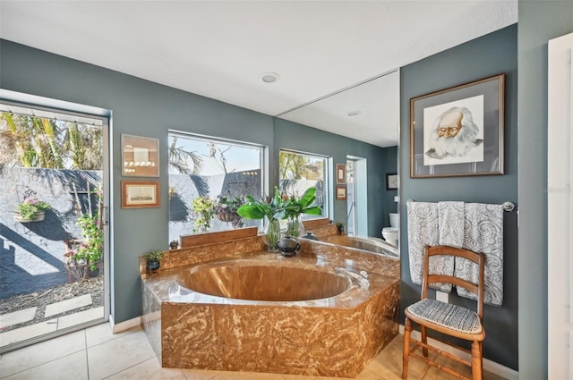 218 Brandywine Cir, Englewood, FL 34223 - interior space featuring tile patterned floors, a garden tub, toilet, and a wealth of natural light