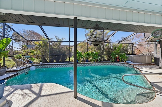 view of pool with a patio area and glass enclosure