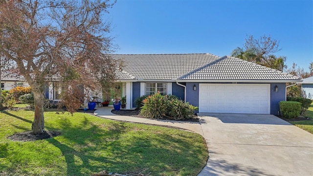 218 Brandywine Cir, Englewood, FL 34223 - single story home featuring a tiled roof, a front lawn, concrete driveway, an attached garage, and stucco siding