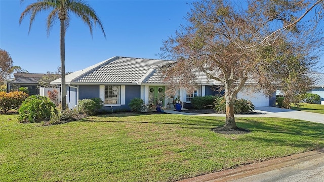 single story home featuring a front yard and a garage