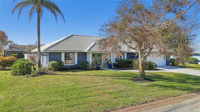 218 Brandywine Cir, Englewood, FL 34223 - view of front of home with concrete driveway, a tiled roof, an attached garage, and a front yard