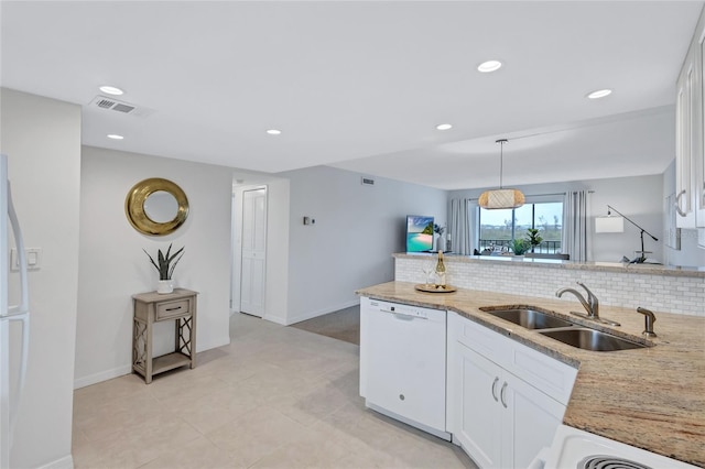 kitchen featuring white appliances, white cabinetry, sink, and backsplash