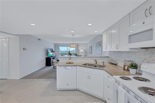 kitchen with sink, kitchen peninsula, white appliances, white cabinets, and pendant lighting