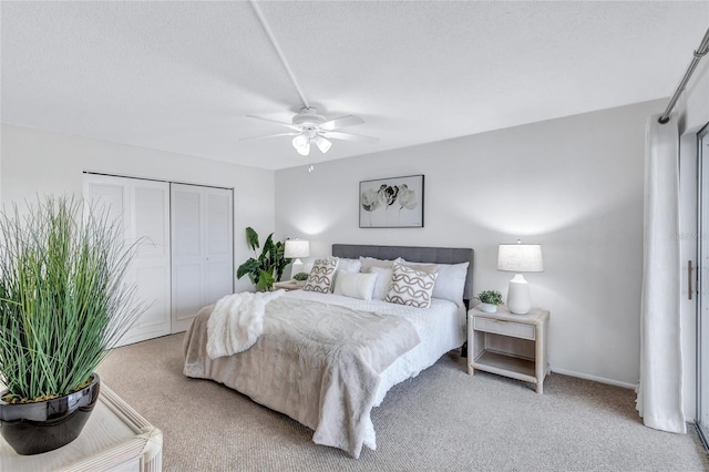 carpeted bedroom featuring a textured ceiling, ceiling fan, and a closet