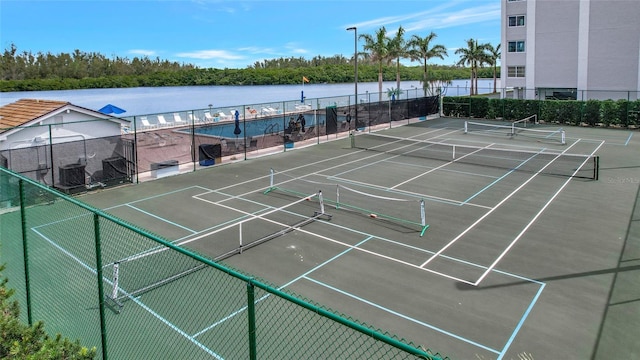 view of sport court featuring a water view