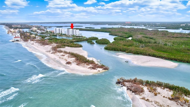 drone / aerial view featuring a beach view and a water view