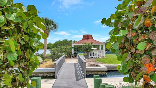 view of dock with a water view and a gazebo