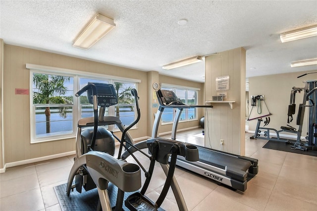 exercise room featuring a healthy amount of sunlight and a textured ceiling