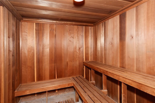 view of sauna / steam room featuring wood ceiling and wooden walls