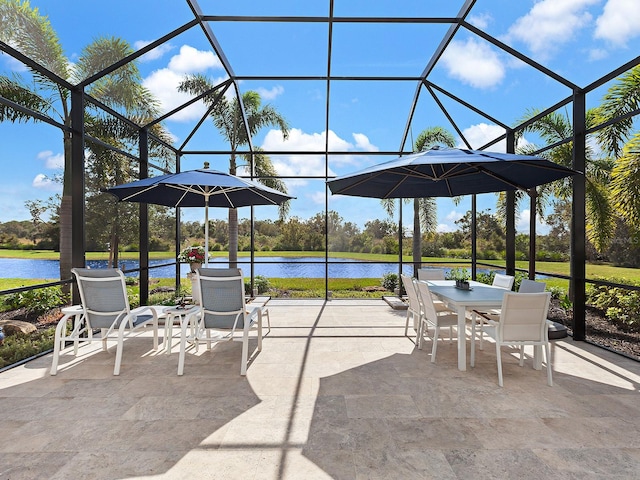 view of patio / terrace with a water view and glass enclosure