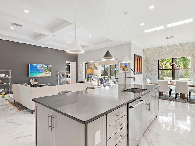 kitchen with dishwasher, sink, decorative light fixtures, and an island with sink