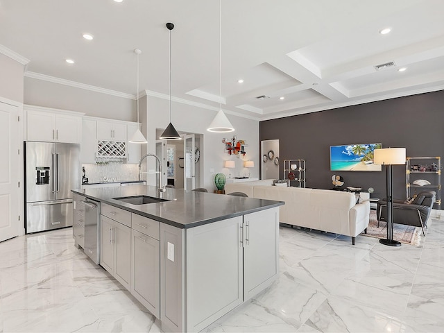 kitchen with beam ceiling, sink, coffered ceiling, a center island with sink, and appliances with stainless steel finishes