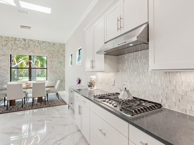 kitchen featuring white cabinets, tasteful backsplash, plenty of natural light, and stainless steel gas cooktop