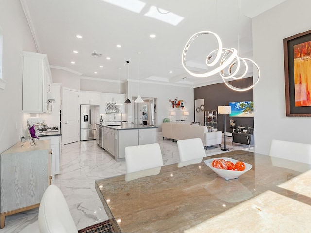 dining room with sink and ornamental molding