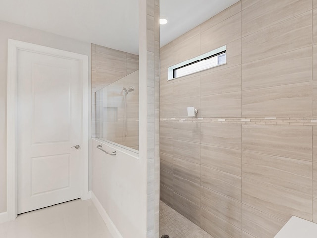 bathroom featuring a tile shower and tile patterned floors