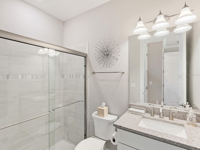 bathroom with toilet, an enclosed shower, vanity, and an inviting chandelier