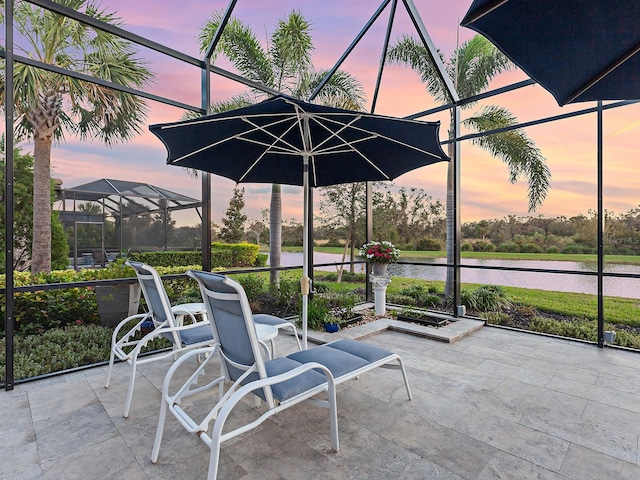 unfurnished sunroom featuring a water view