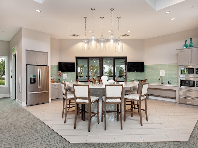 dining room with light tile patterned floors and sink