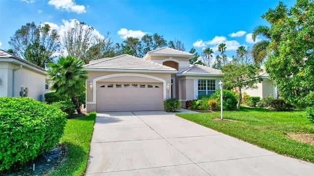 view of front of home featuring a front yard and a garage