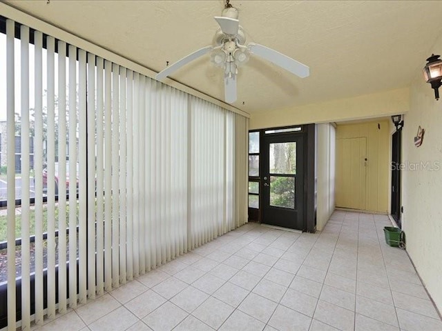 interior space with ceiling fan and light tile patterned floors