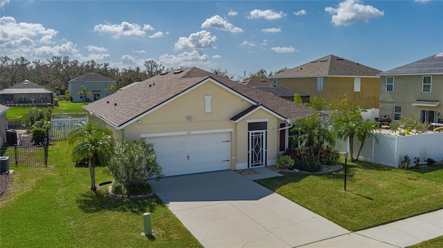 view of front of house with central air condition unit, a front lawn, and a garage