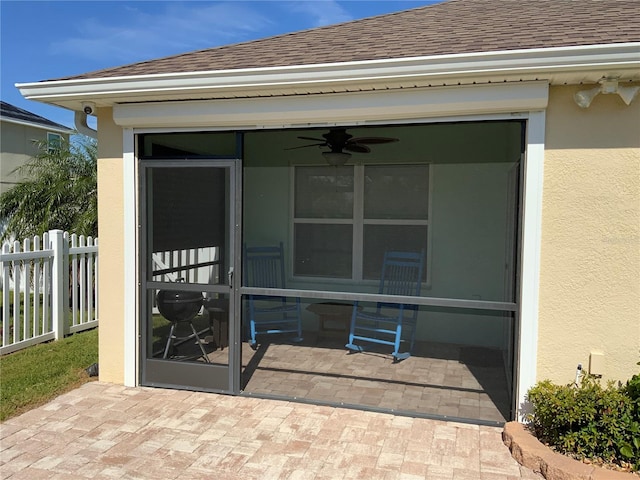 entrance to property featuring a patio and ceiling fan