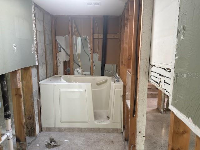 bathroom featuring a tub to relax in