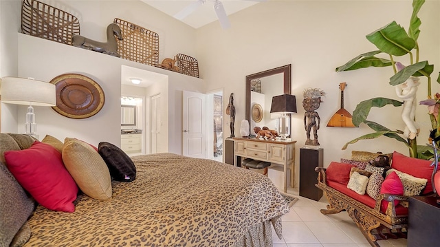 bedroom featuring light tile patterned floors, a high ceiling, and ceiling fan