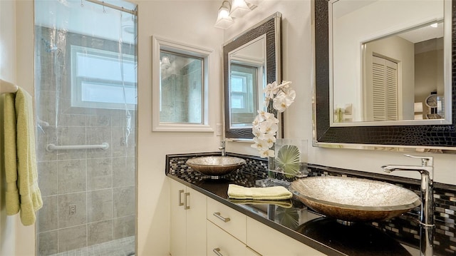 bathroom with vanity, walk in shower, and a wealth of natural light